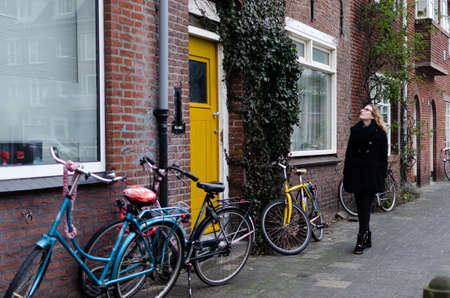 Photograph of a Spanish blonde girl dressed in black walking through the winter streets of a Dutch...