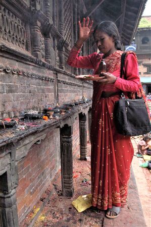 NEPAL BHAKTAPUR IN WOMAN IN PRAYER WAITING TO RECEIVE THE BLESSING DURING THE TEEJ FESTIVALのeditorial素材