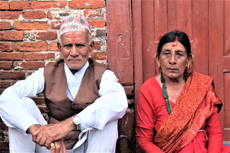 NEPAL BHAKTAPUR AN ELDERLY COUPLE SITTING ON A STEP OF A HINDU TEMPLEのeditorial素材