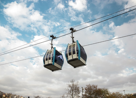 Funicular - one of the popular Istanbul urban transport. Modular cabins cable car against the bright sky and clouds.の写真素材