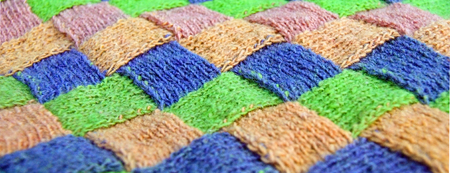 Colorful pink, green, blue, orange, knitted pattern of wool cardigan. Rustic wool front viewの写真素材