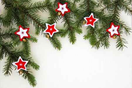 Christmas decoration background with red and wight felt stars and snowflakes with golden bells near...