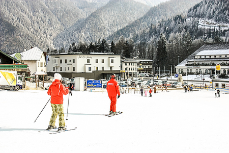Skiing resort Semmering, Austria, february. Alpine ski school.Instructor and student in red colorful ski equipment. Skier learning and exercising skiing.のeditorial素材