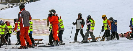 Children's alpine ski school. Skiing resort Semmering, Austria, february 2011. Instructor and children students in colorful ski equipment.. Little skier kids learning and exercising skiing. Web bannerのeditorial素材