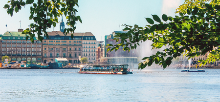 Alster Lake in Hamburg in the central historical district Roterbaum of Hamburg, Germany.June 2010. With historic steam boat for tourists in sunlight. Alsterfontane. Web bannerのeditorial素材