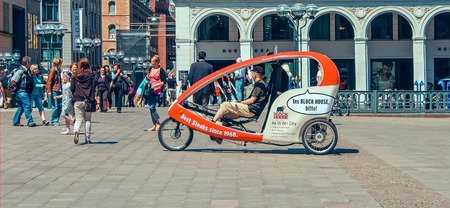 Cycling taxi for tourists at Market square with Hamburg town hall Rathaus and blue sky near lake Alster (Binnenalster) in Altstadt quarter, Hamburg, Germany. June 2010のeditorial素材