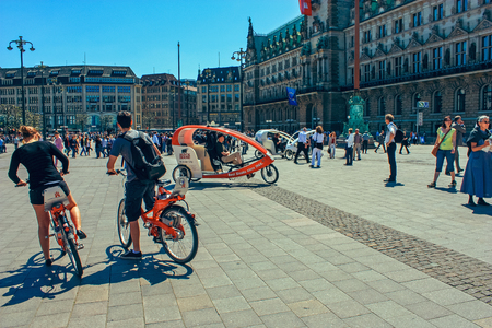 Cycling taxi for tourists at Market square with Hamburg town hall Rathaus and blue sky near lake Alster (Binnenalster) in Altstadt quarter, Hamburg, Germany. June 2010のeditorial素材