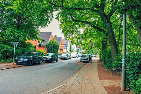 District of Altona, Hamburg, Germany in june 2010. Free road in a residential area between houses with cars, green grass, bushes and treesのeditorial素材