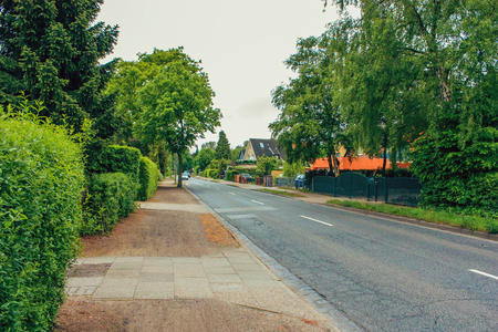 District of Altona, Hamburg, Germany in june 2010. Free road in a residential area between houses with cars, green grass, bushes and treesのeditorial素材