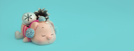 Nice pink pig New Year decoration background with frost pine cone and silver snowflake bell isolated on blue paper background.の写真素材