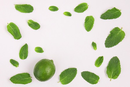 Pattern of food citrus lime and mint leaves isolated on white background. Flatlay, top view, copy...
