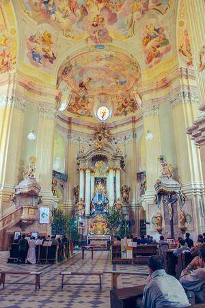 Interior inside the catholic cathedral, Moravia, Czech republic june 2010, people, prayer, murals iconsのeditorial素材