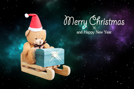 Decoration Santa's helper bear in a red hat flies in a sleigh with a chest of gifts on a starry night sky at Christmas. Front view, close up. Holiday greeting card conceptの写真素材