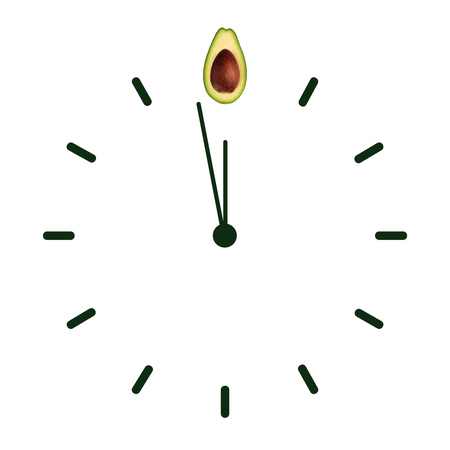 Half ripe green avocado with bone on the clock face with arrows as illustration time healthy lifestyle, emblem proper nutrition vegetarian diet bio brand quility restaurant. Copy space flatlayの写真素材