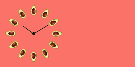 Half ripe green avocado with bone on the clock face with arrows as illustration time healthy lifestyle, emblem proper nutrition vegetarian diet bio brand quility restaurant. Copy space web bannerの写真素材