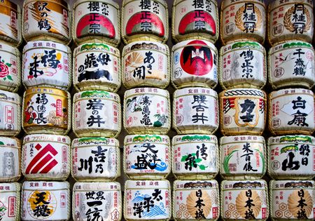 Japanese sake rice wine barrels with decorative writing in a japanese templeのeditorial素材