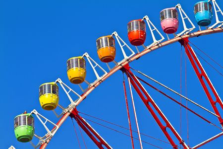 A multi coloured Tokyo's Ferris Wheel with blue sky backgroundの写真素材