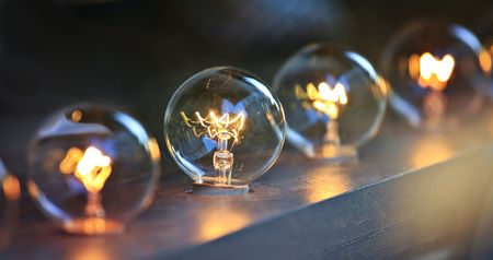 row of glowing orange lit light bulbs