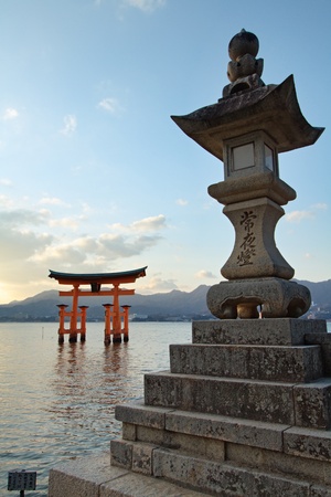 Gate (torii) and stone lantern of the Itsukushima Shrine on Miyajima Island across the bay from Hiroshima in Japan.のeditorial素材