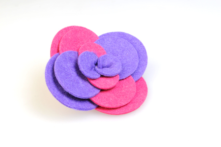 Felt brooch. Handmade stylish flower made felt isolated on a whiteの写真素材