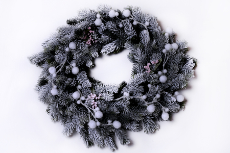 Green christmas wreath with decorations isolated on white backgroundの写真素材