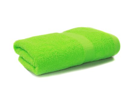 bright green towel folded isolated on white backgroundの写真素材