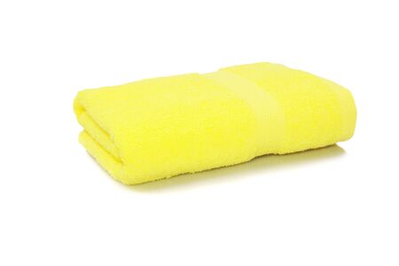 yellow towel rolled isolated on white backgroundの写真素材