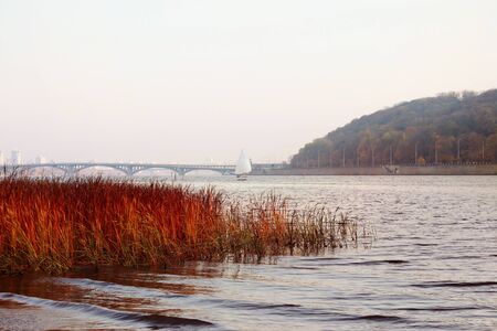 Dnieper river, autumn landscape. River, sailboat and reedsの写真素材