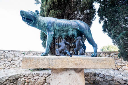 Tarragona, Spain - February 27, 2020: The Capitoline Wolf next to the Roman walls of Tarragona,...