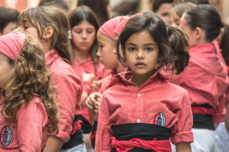 Valls, Spain - October 25, 2015: Portait of a girl during a human tower performance in Santa...
