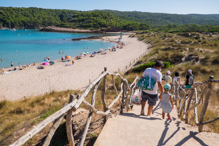 Menorca, Spain - August 7, 2020: Family arriving to Cala Algaiarens, Menorca, Balearic Islands, Spain.のeditorial素材