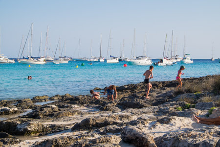 Menorca, Spain - August 3, 2020: Nice bay with sailboats, yachts and playing kids, Cala Son Saura, Menorca, Balearic Islands. Spain.のeditorial素材