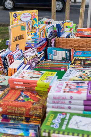 Tarragona, Spain - July 23, 2020: People looking at books with mask and hydroalcoholic gel during Sant Jordi feast in Tarragona, Catalonia.のeditorial素材
