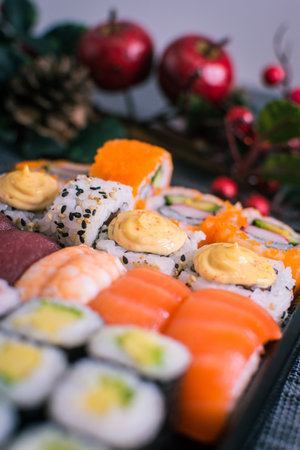Sushi nigiri and maki set with Christmas or New Year concept background. Traditional japanese food.の写真素材