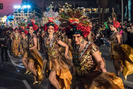 Tarragona, Spain - February 19, 2020: Participants in colorful and bright costumes take part in a...