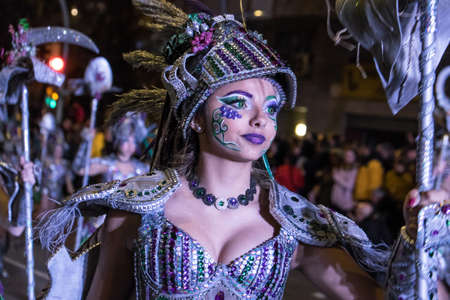 Tarragona, Spain - February 19, 2020: Participants in colorful and bright costumes take part in a carnival parade in Tarragona, one of the best carnivals in Spain.のeditorial素材