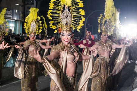 Tarragona, Spain - February 19, 2020: Participants in colorful and bright costumes take part in a carnival parade in Tarragona, one of the best carnivals in Spain.のeditorial素材