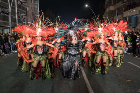Tarragona, Spain - February 19, 2020: Participants in colorful and bright costumes take part in a carnival parade in Tarragona, one of the best carnivals in Spain.のeditorial素材