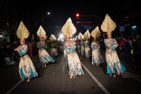 Tarragona, Spain - February 19, 2020: Participants in colorful and bright costumes take part in a carnival parade in Tarragona, one of the best carnivals in Spain.のeditorial素材