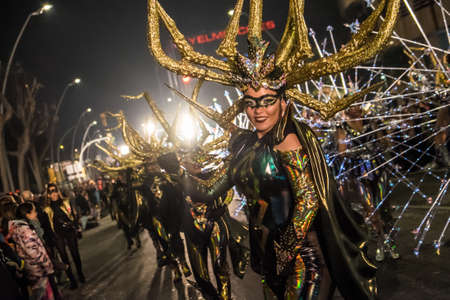 Tarragona, Spain - February 19, 2020: Participants in colorful and bright costumes take part in a carnival parade in Tarragona, one of the best carnivals in Spain.のeditorial素材