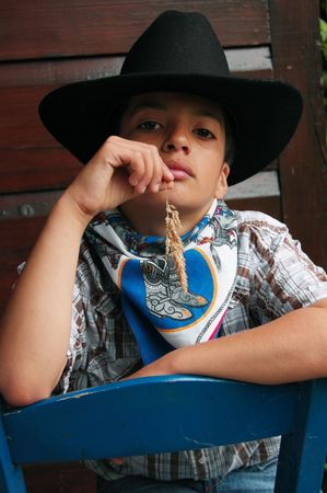 little cowboy with grass in the mouthの写真素材