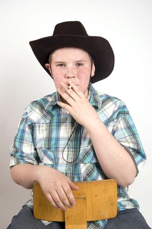 young handsome cowboy smoking a cigaretteの写真素材