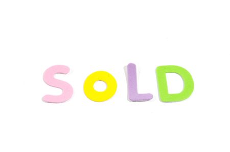 sold in colorfull letters isolated on whiteの写真素材