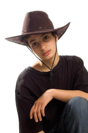 teenage boy wearing an original american leather cowboy hat  on whiteの写真素材