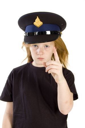 young girl with police hat is giving a warning sign on whiteの写真素材