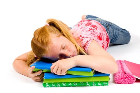 Child sleeping while working on homework on white background
の写真素材