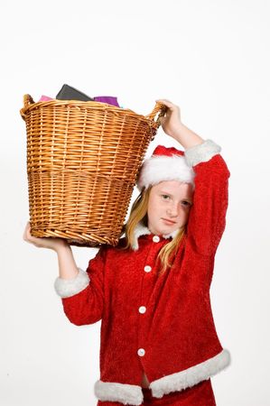 little santa claus holding a basket full with presentsの写真素材