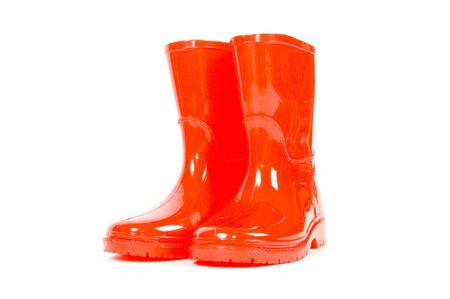 Red children rain boots on a white backgroundの写真素材