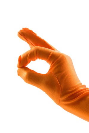 hand in orange glove is making the ok sign over whiteの写真素材