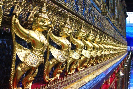 Golden garuda statues stand in a rowの写真素材